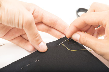 woman sews clothes hands