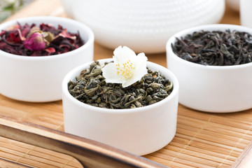 dry herbal teas in white bowls on a tray