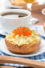scramble eggs with red caviar on a wheat bun for breakfast