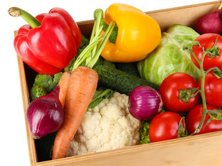 Fresh vegetables in wooden box on white background