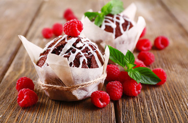 Tasty cupcakes with raspberries on table close-up