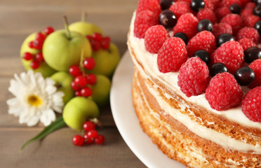 Tasty cake with fresh berries on wooden table