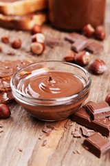 Sweet chocolate cream in bowl on table close-up