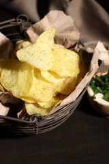 Tasty potato chips in metal basket
