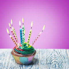 Birthday cupcake with burning candles