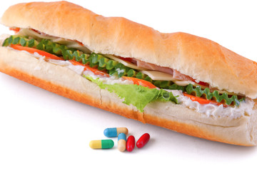 Pills and two hot dogs with various ingredients.