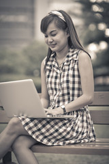 a young asian woman using laptop