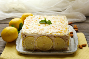 Tasty lemon cake on table at home