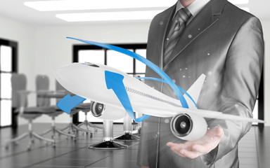 Businessman with airplane over his hand