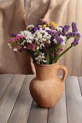 Beautiful bouquet of bright flowers in pitcher