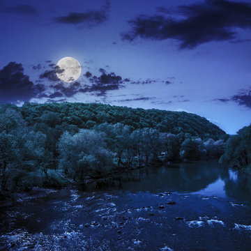 wild mountain river near the mountain at night