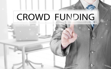 Businessman pushes virtual crowd funding button