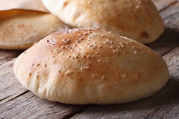 freshly baked pita bread on the wooden table closeup