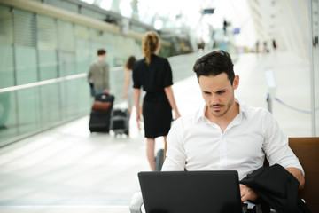 handsome businessman public station working computer wifi area