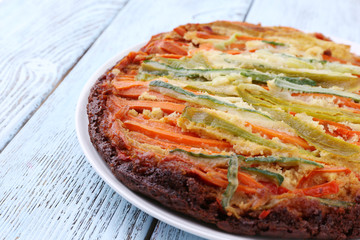 Casserole with vegetables on plate on table close-up