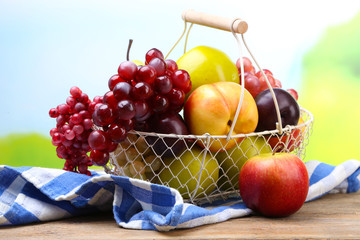 Assortment of juicy fruits in wicker basket