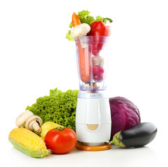 Blender with fresh vegetables isolated on white