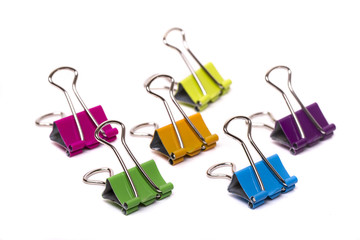 several colorful office binder clips 