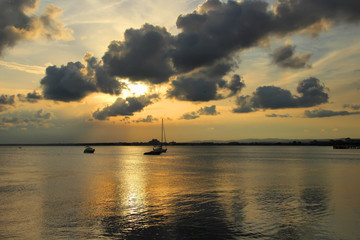 Naklejka na ściany i meble Beautiful sunset and yacht, drifting at sea.