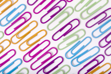 vertical lines of colorful office paper clips 