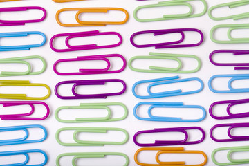 vertical lines of colorful office paper clips 