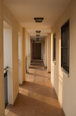 Spanish Apartment Hallway, sun's rays slanting across the floor
