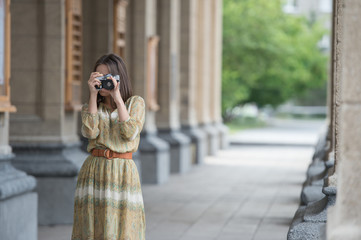 Traveler girl making photo retro camera