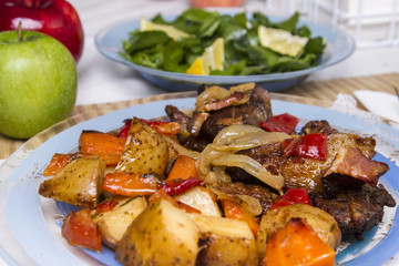 baked meat with potatoes, and watercress salad.