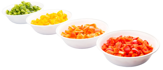 Colorful chopped capsicums in white bowls over white background