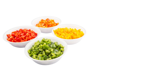 Colorful chopped capsicums in white bowls over white background