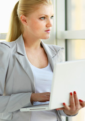 young woman holding a laptop