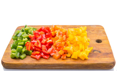 Colorful chopped capsicums wooden cutting board 