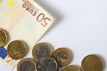 Money euro coins and bills close up isolated on white