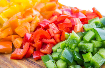 Colorful chopped capsicums wooden cutting board 
