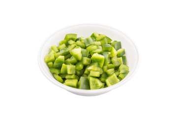 Chopped green capsicums in white bowls over white background 