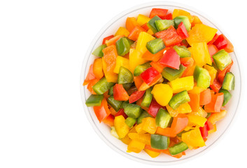 Mix colorful chopped capsicum in a bowl over white background