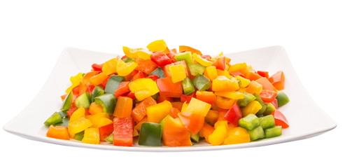 Mix colorful chopped capsicums in a plate over white background
