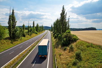 The rural landscape with a highway leading poplar alley