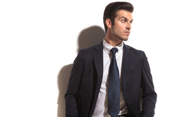 fashion business man looking over shoulder to his side