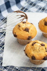 Tasty home made muffins with whisk covered in melting chocolate