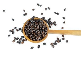 Fresh coffee beans with wooden spoon isolated over white