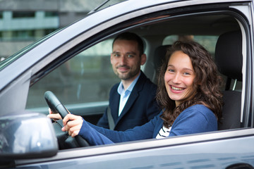 Young business man couple in their brand new car