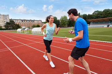 Sport coach training a young attractive woman