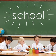 School against cute pupils sitting at desk