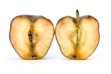 Old apple cut in two half on white background