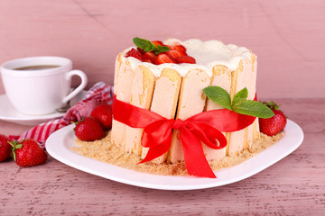 Tasty cake Charlotte with fresh strawberries on wooden table