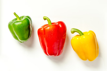 Paprika rot gelb gruen nebeneinander auf weiss