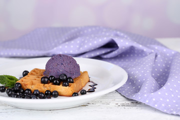 Tasty belgian waffles with ice cream on wooden table