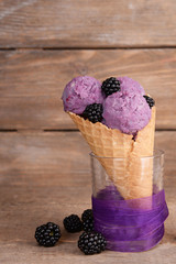 Tasty ice cream with berries in waffle cone