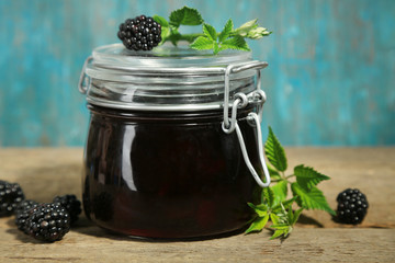 Tasty blackberry jam and fresh berries, on wooden table © Africa Studio